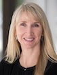 Anita Moon-Grady, MD, UCSF, smiling with medium length blonde hair and dark blazer on grey backdrop