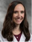 Jennifer C. Cohen, MD, Duke University, smiling in white lab coat medium length hair and light grey backdrop