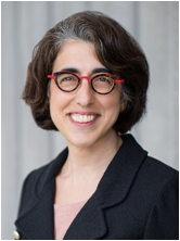 Tippi MacKenzie, MD, UCSF, smiling in dark blazer red shirt and short brown hair on grey backdrop