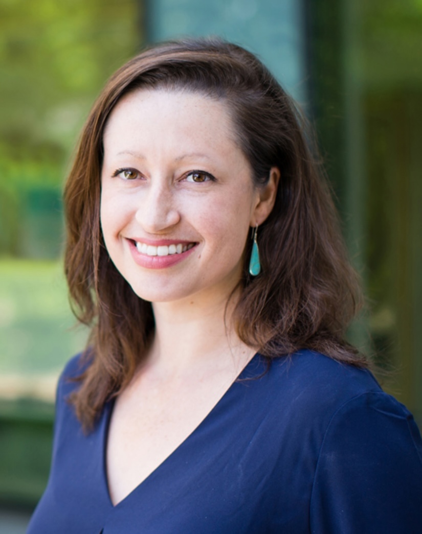 Teresa Sparks, MD, MAS, UCSF smiling in dark top with medium length brown hair in outdoor setting