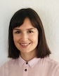 Julia Brown, PhD, UCSF, smiling in light pink top with short brown hair and light background